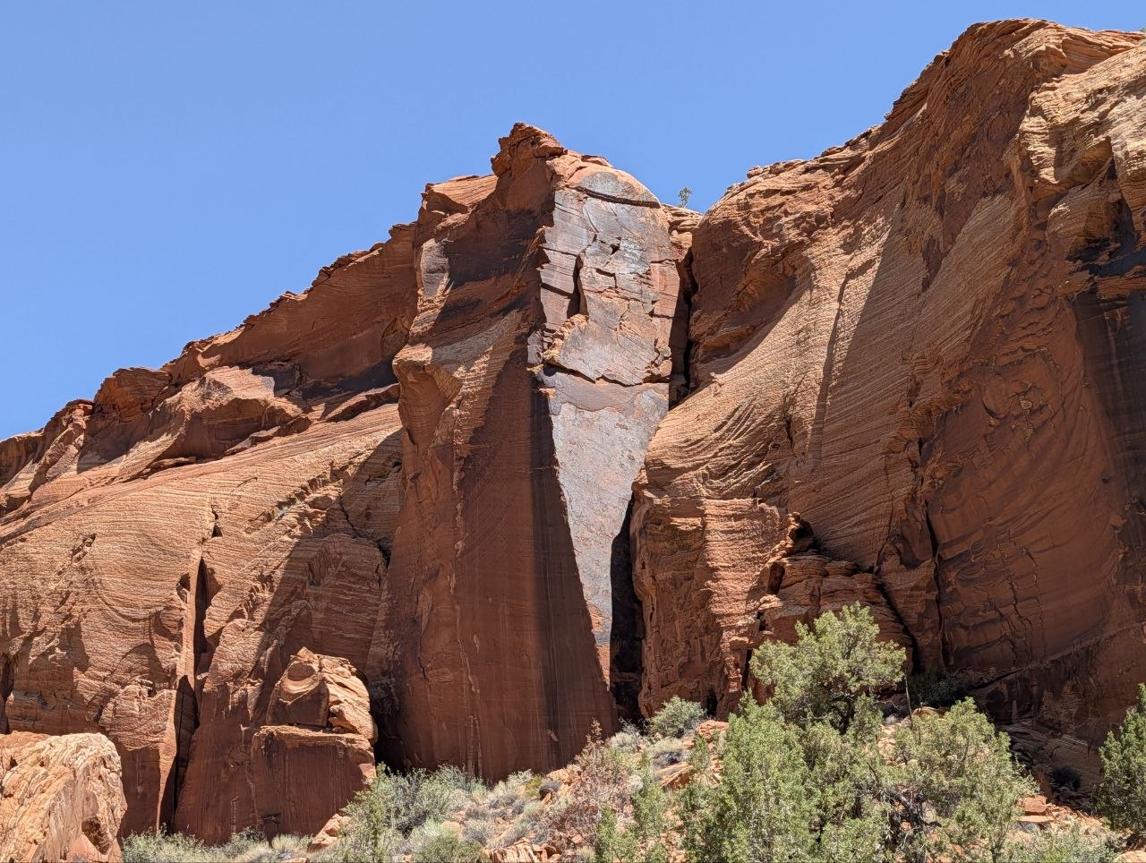 Red sandstone fins and columns under clear blue sky