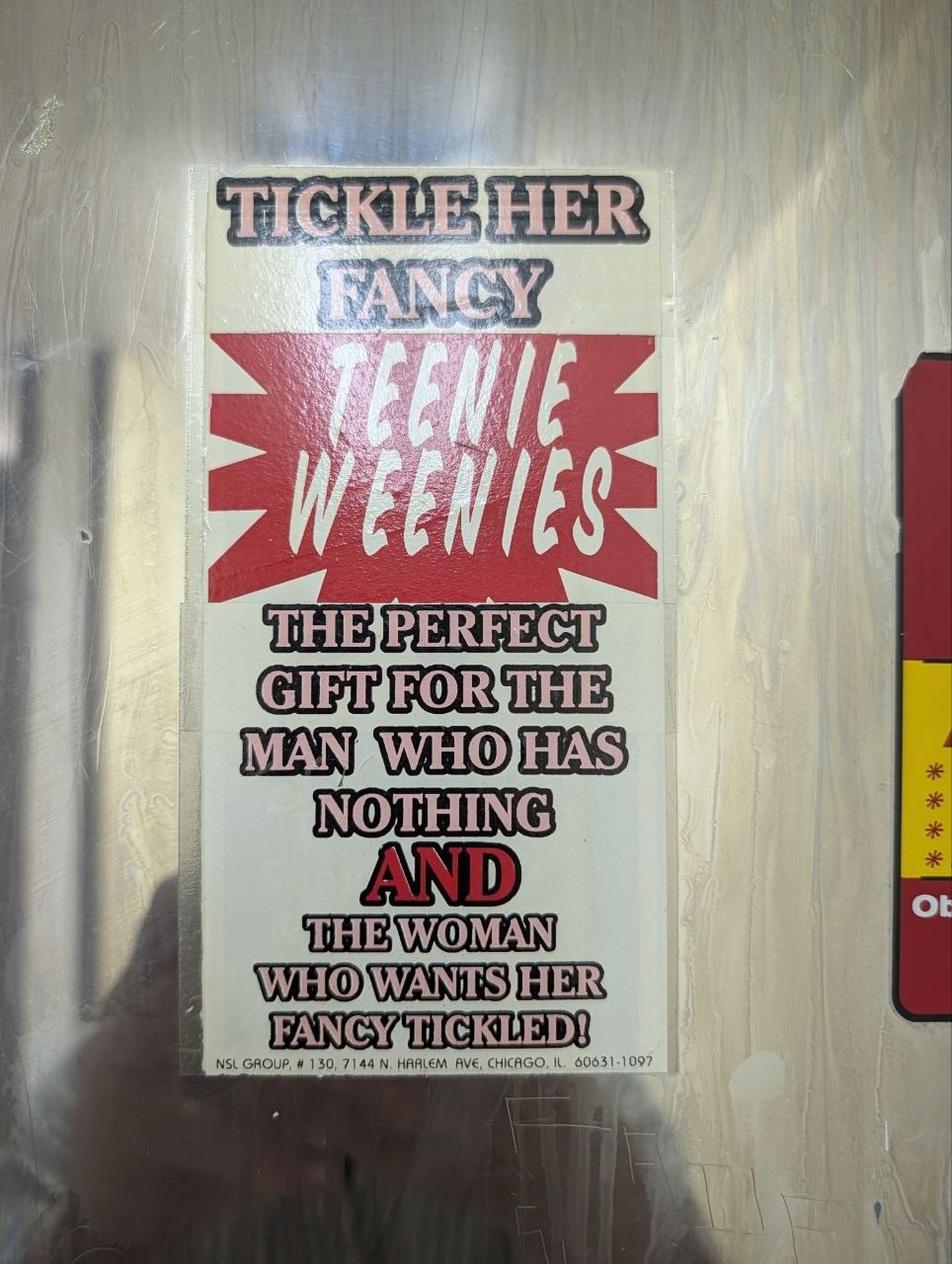 A bathroom vending sticker reading Tickle Her Fancy Teenie Weenies